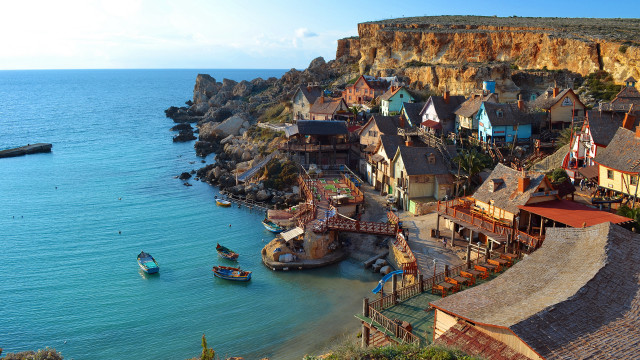 Cliffside village ocean boat castle free wallpaper for desktop - medium preview image