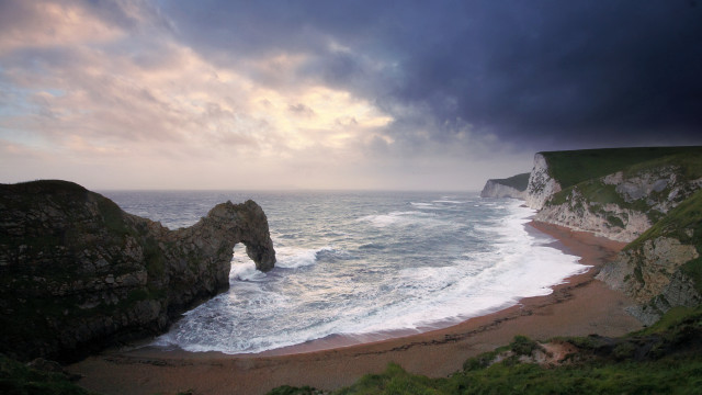 Beach rock formation stormy sky free wallpaper for desktop - medium preview image