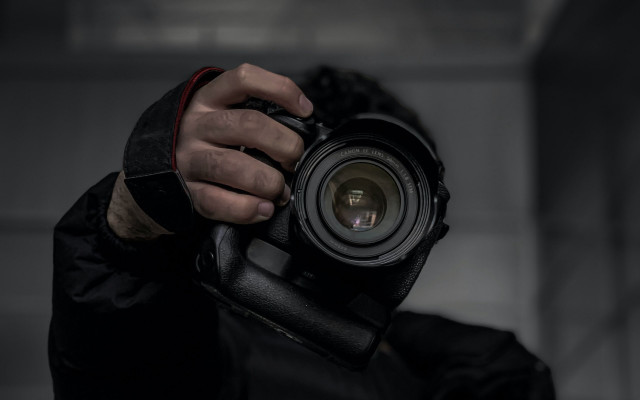 Man holding camera dark room #2 free wallpaper for desktop - medium preview image