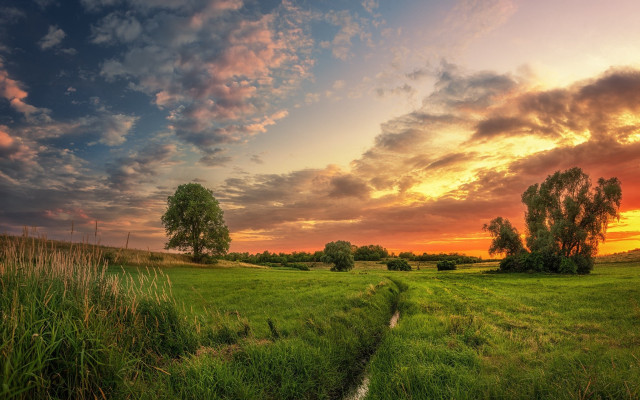 Grassy field stream sunset clouds free wallpaper for desktop - medium preview image