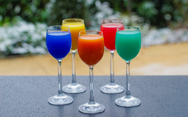 Four colored glasses table blurry free wallpaper for desktop - medium preview image