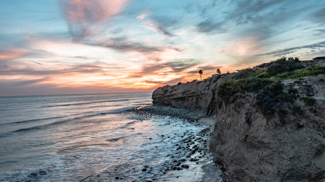 Beach cliff sunset water reflection free wallpaper for desktop - medium preview image