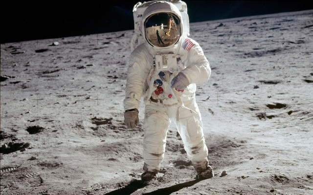 Astronaut walking on moon arm free wallpaper for desktop - medium preview image