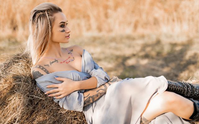 Tattooed woman hay bale field free wallpaper for desktop - medium preview image