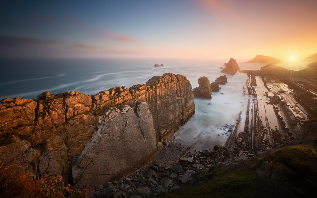 Rocky cliff water sunset mountains free wallpaper for desktop - medium preview image