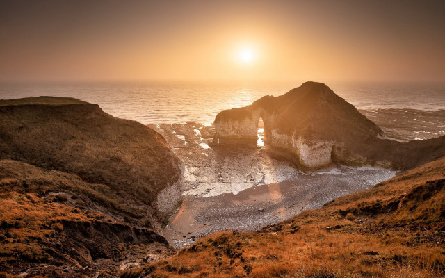 Sunset ocean rocky outcropping beach free wallpaper for desktop - medium preview image