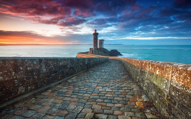 Stone lighthouse rocky shore sunset free wallpaper for desktop - medium preview image