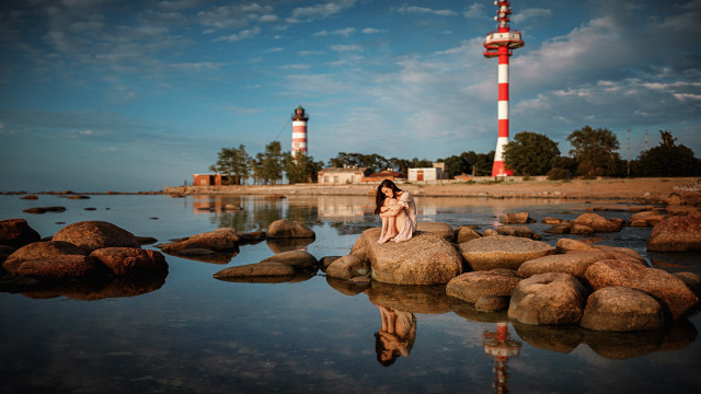 Woman rock lighthouse reflection cinematic free wallpaper for desktop - medium preview image