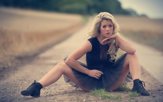 Woman sitting on tire outdoors #2 free wallpaper for desktop - medium preview image