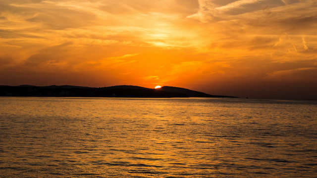 Sunset water island clouds dusk free wallpaper for desktop - medium preview image