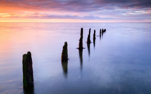 Wooden posts water sunset cloudy free wallpaper for desktop - medium preview image