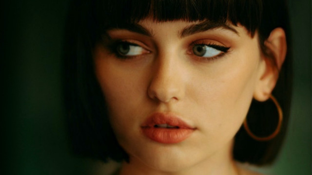 Woman hoop ears green background free wallpaper for desktop - medium preview image