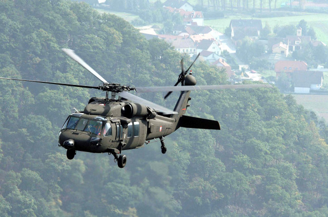 Helicopter flying lush green hillside #2 free wallpaper for desktop - medium preview image