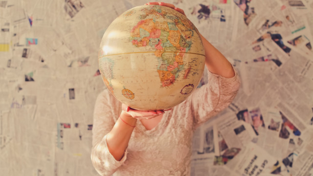 Woman globe wall of newspapers free wallpaper for desktop - medium preview image