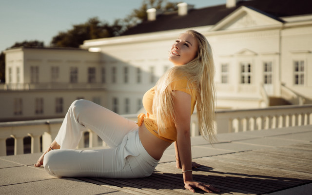 Woman yellow top roof sitting free wallpaper for desktop - medium preview image