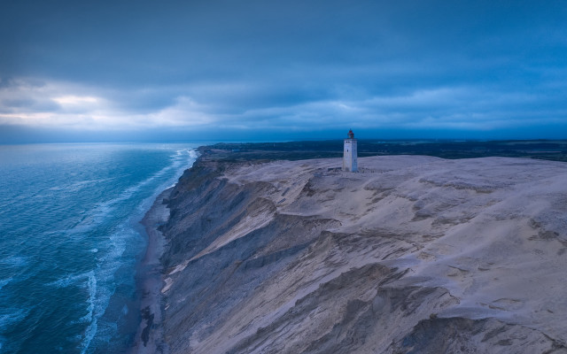 Lighthouse cliff ocean cloudy sky free wallpaper for desktop - medium preview image