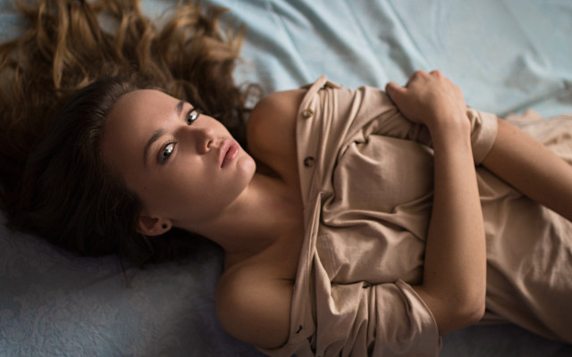 Woman laying blowing hair portrait free wallpaper for desktop - medium preview image