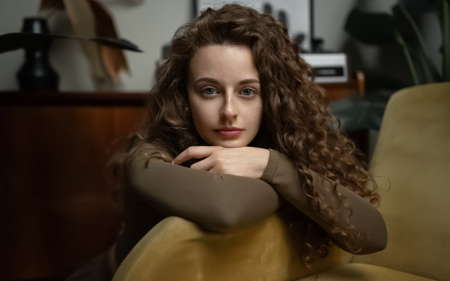 Serious woman couch blue eyes free wallpaper for desktop - medium preview image