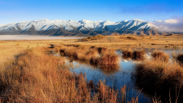 River drygrass mountains blue sky free wallpaper for desktop - medium preview image