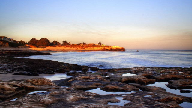 Beach rocky shore houses sunset free wallpaper for desktop - medium preview image