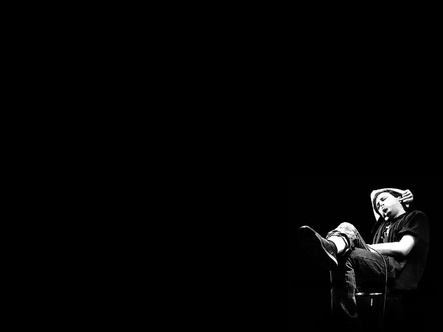 Man sitting chair feet stool free wallpaper for desktop - medium preview image