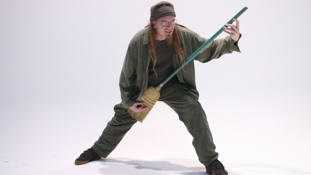 Man green outfit holding pole free wallpaper for desktop - medium preview image