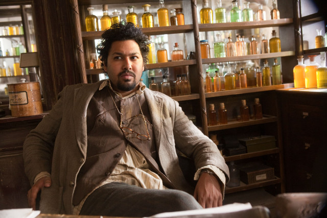 Afrofuturism man sitting bar shelf free wallpaper for desktop - medium preview image