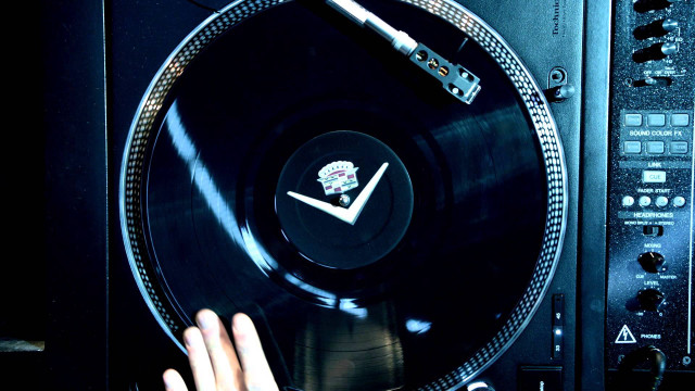 Person holding record player clock free wallpaper for desktop - medium preview image
