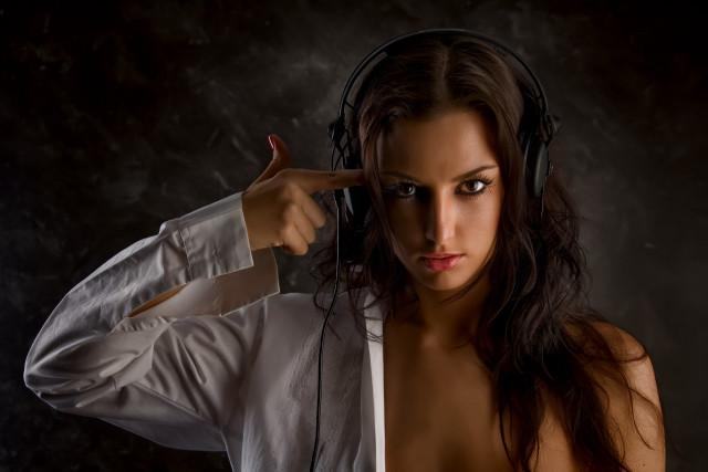 Woman headphones dark room promotional free wallpaper for desktop - medium preview image