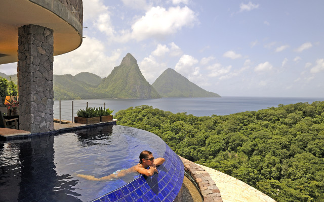 Man swimming mountains cityscape beach free wallpaper for desktop - medium preview image