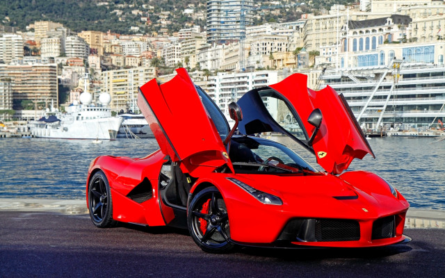 Red sports car waterfront cityscape free wallpaper for desktop - medium preview image