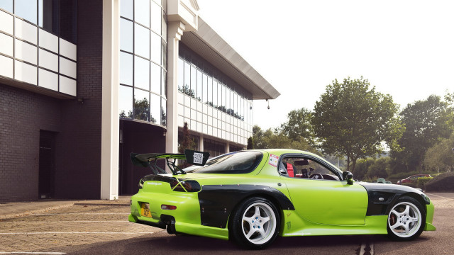 Green car building bike rack free wallpaper for desktop - medium preview image