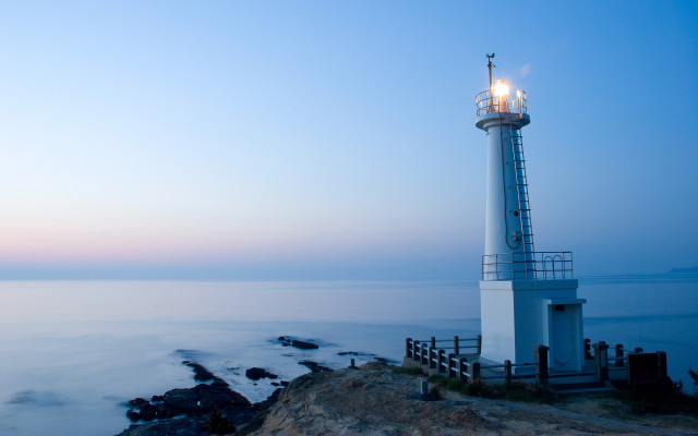 Lighthouse rocky cliff ocean dusk free wallpaper for desktop - medium preview image