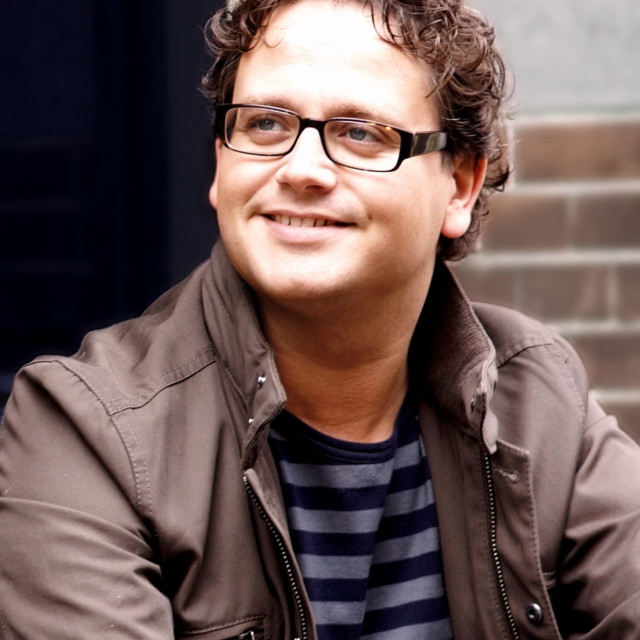 Man glasses smiling brick building free wallpaper for tablet - medium preview image