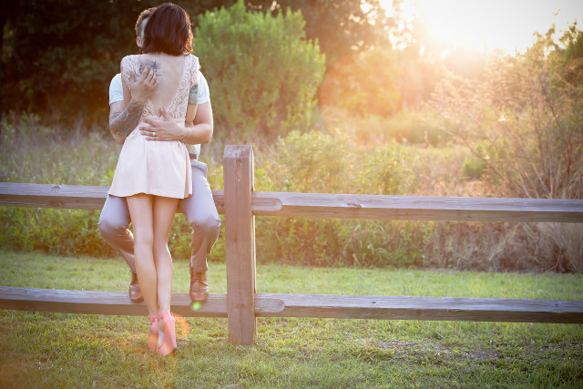 Couple standing fence grass field free wallpaper for desktop - medium preview image