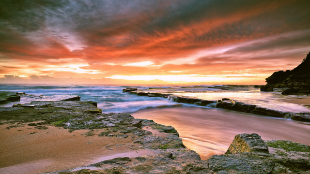 Sunset rocky beach water cityscape free wallpaper for desktop - medium preview image