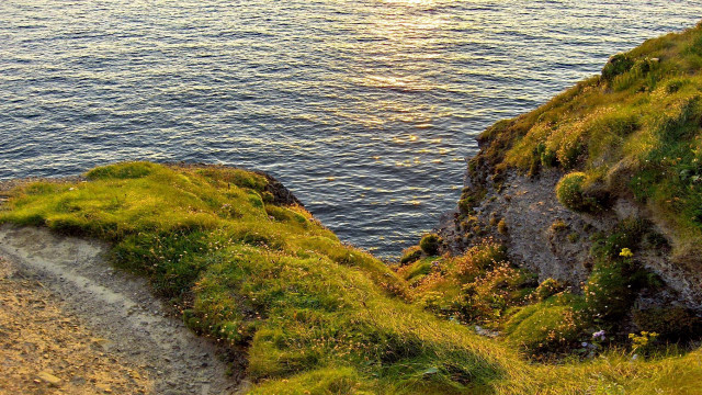 Grassy cliff path water boat free wallpaper for desktop - medium preview image