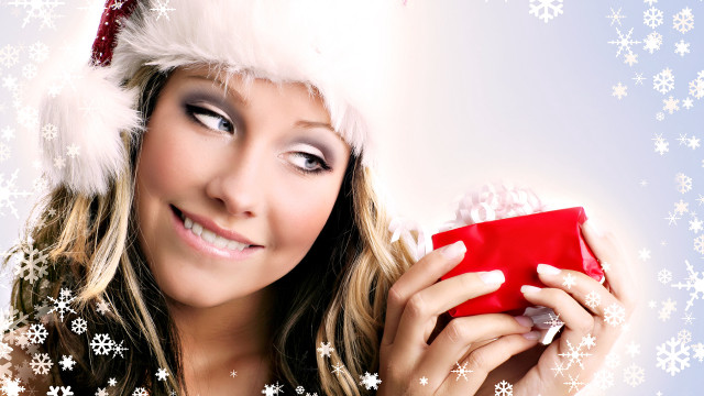 Santa hat woman holding gift free wallpaper for desktop - medium preview image