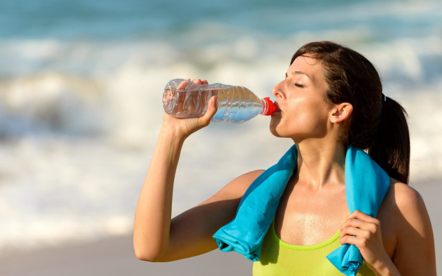 Woman drinking beach towel water free wallpaper for desktop - medium preview image
