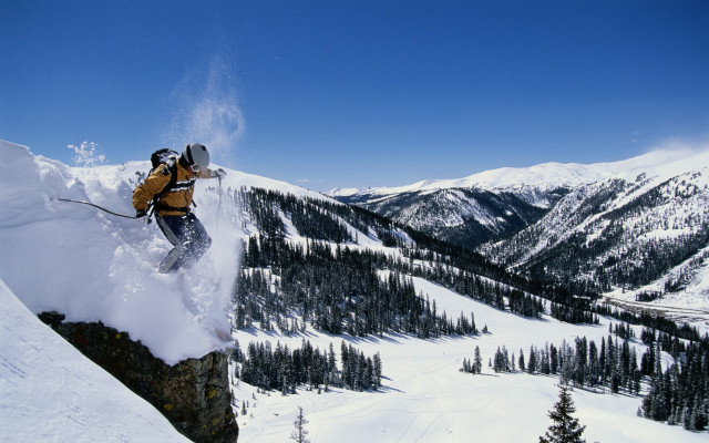 Man skier jumping cliff mountains free wallpaper for desktop - medium preview image