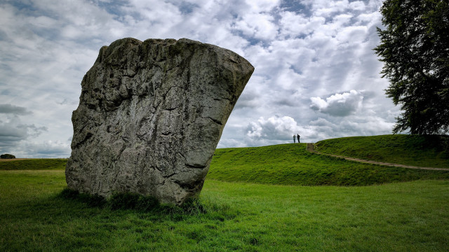 Large rock grassy field person free wallpaper for desktop - medium preview image