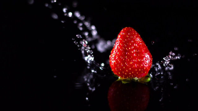 Strawberry waterdroplets blackbackground macro photography free wallpaper for desktop - medium preview image