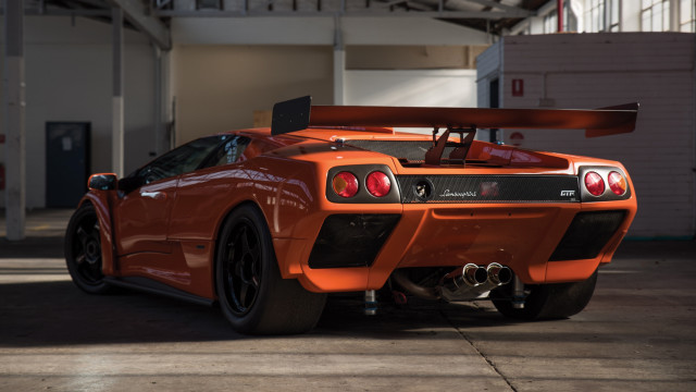 Orange sports car garage surfboard free wallpaper for desktop - medium preview image