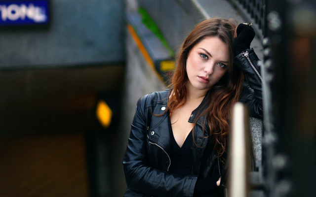 Woman blackjacket leaning wall bokeh free wallpaper for desktop - medium preview image