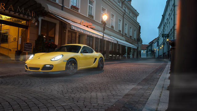 Yellow sports car cobblestone street free wallpaper for desktop - medium preview image