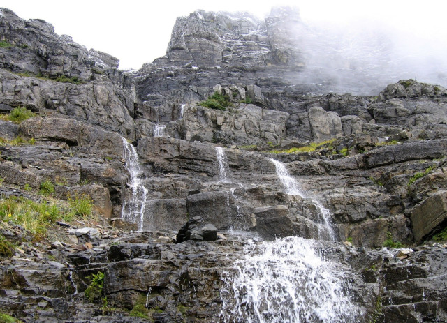 Waterfall rocks foggy sky person free wallpaper for desktop - medium preview image