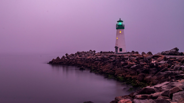 Lighthouse rocky shore green light free wallpaper for desktop - medium preview image