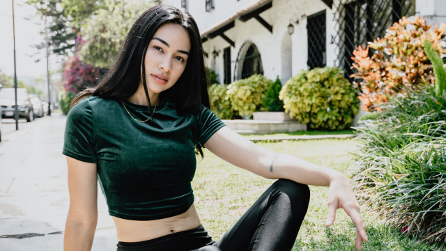 Woman green shirt black pants free wallpaper for desktop - medium preview image