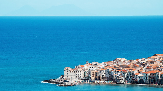 Small island buildings boat ocean free wallpaper for desktop - medium preview image