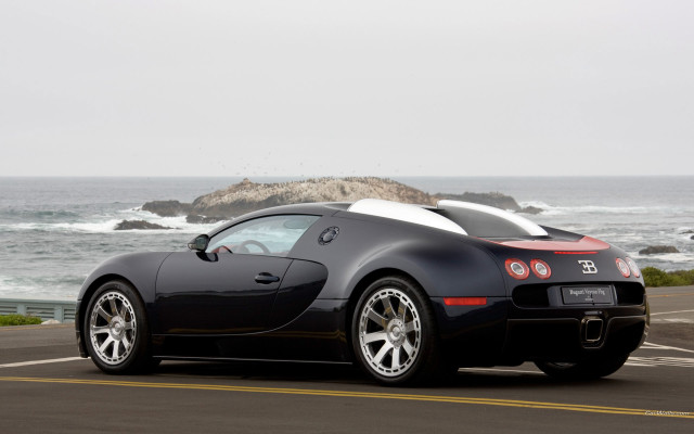 Black sports car ocean rock free wallpaper for desktop - medium preview image